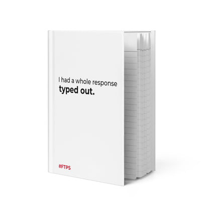 A white hardcover notebook or journal standing upright on a white background, with the front cover printed in black text reading 'I had a whole response typed out.' and a small red '#FTPS' mark near the bottom left.